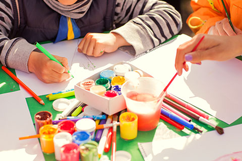 This is a stock photo. An up close view of an arts and crafts table.